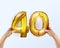 Golden metal balloon number forty 40. party decoration with Golden balloons. The number 40 is in your hand.Anniversary sign for a