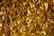 Golden metal chrome foil paper background with bold crumpled texture