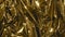 Golden metal foil, wrinkled and shiny. Close-up, abstract image background