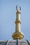 Golden metallic figure on top of a dome