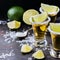 Golden mexican tequila shot with green lime and salt