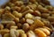 Golden mixed nuts, snacks, chips for beer close-up with selective focus