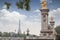 Golden monuments on the bridge Pont Alexander III bridge in Paris overlooking the background the eiffel tower