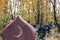 Golden muslim crescent moon on a granite tombstone. Islamic grave with half moon in the autumn cemetery