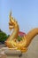 Golden naga statue at the temple stairs, The great serpent guardian of Buddha, wat Podhisomborn.