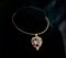 Golden necklace with gemstone pendant