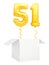 Golden number fifty one inflatable balloon with golden ribbon flying out of blank white box isolated on white background