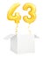 Golden number forty three inflatable balloon with golden ribbon flying out of blank white box isolated on white
