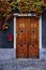 Golden oak wooden door surrounded by leaves in Nuits-Saint-Georges, French Bourgogne