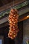 Golden onions tied up to dry in autumn