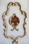 Golden ornament on the wall of the palace. Vintage style on antiques. Golden monograms with a precious stone