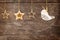 Golden ornaments hanging over wooden background