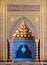 Golden ornate arched mihrab niche with floral pattern, blue Turkish ceramic tiles and arabic calligraphy, Cairo, Egypt