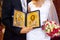 Golden Orthodox icons of The virgin and Jesus in hands of bride and groom