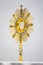 Golden Ostensory or Monstrance for worship at a Catholic church ceremony in detailed view.