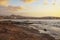 Golden overcast sunrise over El Medano town, in Tenerife with the limestone coast in the foreground