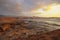 Golden overcast sunrise over El Medano town, in Tenerife with the limestone coast in the foreground