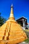 Golden pagoda detail is `Mon` architectural style at temple located in Kanchanaburi Province, Thailand