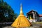 Golden pagoda detail is `Mon` architectural style at temple located in Kanchanaburi Province, Thailand