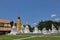 A golden pagoda stands out from the field of white pagodas.