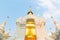 The golden pagoda at Wat Suan Dok, Chiangmai, Thailand. The beautiful pagoda in contrasted with beautiful blue sky and clouds