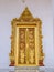Golden painted door frame of the temple in Thailand.