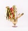 Golden party whistles with stripes, spatula and brush gathered in a golden glass