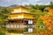 Golden Pavilion with reflections on water in red maple leave, au