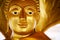 Golden peaceful Buddha statue smiling peaceful face