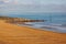 Golden pebble beach and rock groyne