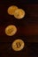 Golden physical bitcoins lies on dark wooden backgound, close up. High resolution photo. Cryptocurrency mining concep