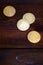 Golden physical bitcoins lies on dark wooden backgound, close up. High resolution photo. Cryptocurrency mining concep