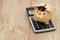 A golden piggy bank with grad cap and calculator on wood background