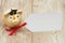 A golden piggy bank with grad cap and gift tag on wood background