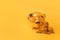 Golden piggy bank with money towers on yellow background. Stack of euro coins near golden money box. Money pig, money saving,