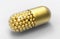 Golden pills and golden balls inside capsule