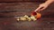 Golden pine cones and acorns pouring out of tiny orange bucket