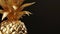 Golden pineapple made of gold against dark background. Perfect for financial, success and high-value themed visuals