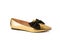Golden pointy toe shoe with black bow isolated on white. Single leather shiny sole on white background. Festive