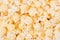 Golden popcorn as texture, background. Top view, closeup.