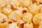 Golden popcorn macro with blur, texture, background.