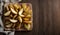 Golden Potato Wedges on Wooden Table with Cloth Backdrop, Copy Space