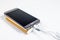 Golden powerbank with smart phone on background