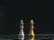 A golden queen chess piece and a silver queen chess piece are standing together on a chessboard on dark background.