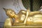 Golden reclining Buddha statue in buddhist temple in Thailand