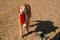 Golden Retriever with Christmas Santa Hat at the Beach at Golden Hour Playing.