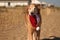 Golden Retriever with Christmas Santa Hat at the Beach at Golden Hour Playing.