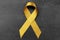 Golden ribbon on dark background. Children cancer