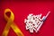 Golden ribbon and medicine. concept - a symbol of childhood cancer, pediatric oncology