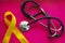 Golden ribbon and medicine. concept - a symbol of childhood cancer, pediatric oncology